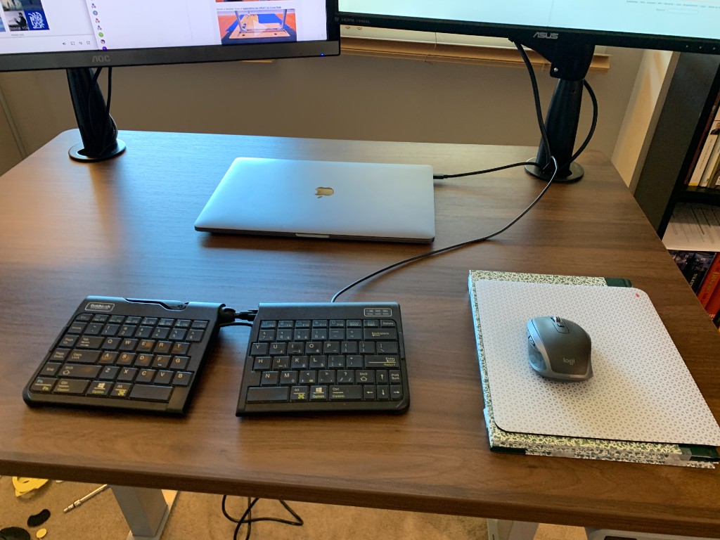 Goldtouch Go2 split membrane keyboard on a desk with a Logitech mouse