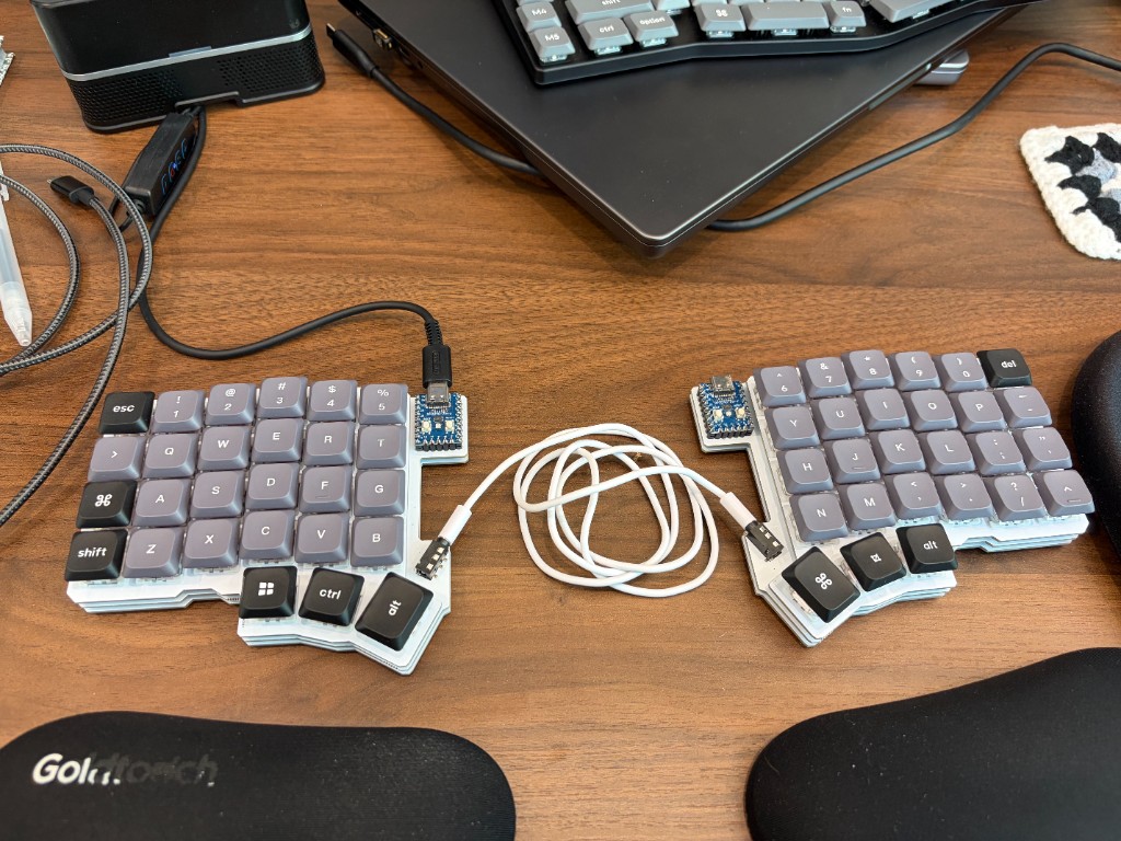 Silakka54 split column-stagger keyboard on a desk, with a Keychron K15 Max visible in the background